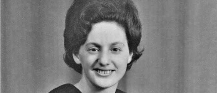 A female graduate from the 1960s with a beehive hairstyle