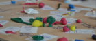 Creative arts based engagement workshop. Clay models on wooden tabletop.
