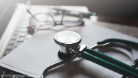 Stethoscope on a desk with files