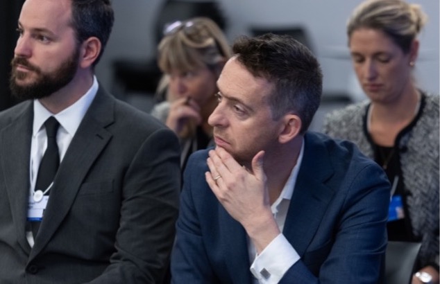 Professor Grove sitting at the project announcement launch, World Economic Forum