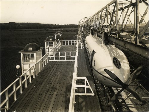 Photographic print showing completed Bennie railplane car mounted on aerial network - railplane is a four-bladed propeller version, c1930. (GUAS Ref: DC 85/3/20. Copyright reserved.) 