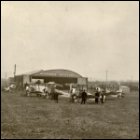 Photograph print, showing eight Sopwith Camel aeroplanes in front of the Beardmore Aeroplanes hangar, built under licence at Dalmuir, Dunbartonshire.  From a William Beardmore & Co Ltd photographic album, c1908-1923.  (GUAS Ref: UGD 100/1/11/8. Copyright reserved.) 