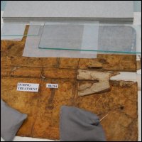 This photograph shows the outside front, spine and back cover of the logbook during surface cleaning treatment.  (GUAS Ref: UGC 182. Copyright reserved.) 