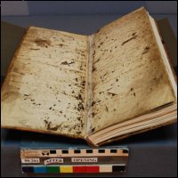 This photograph was taken after conservation treatment.  The image shows textblock opening in the cradle after repair by using the original boards and original sewing strips of parchment.  (GUAS Ref: UGC 182. Copyright reserved.) 