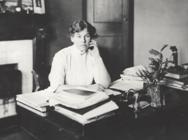 Dame Anne Louise McIllroy sitting in her office, with permission of Glasgow University Archive Services