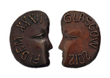 Obverse and reverse of medal shaped like the profile of a face