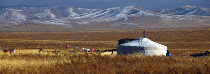 Hut in front of mountains in Mongolian landscape