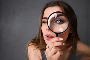 Young woman with magnifying glass