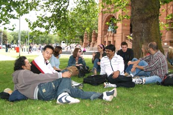 Mixed student group sitting on grass