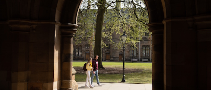 Students sitting on grass in the quadrangle