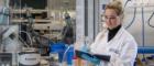 Student at work taking notes in a lab