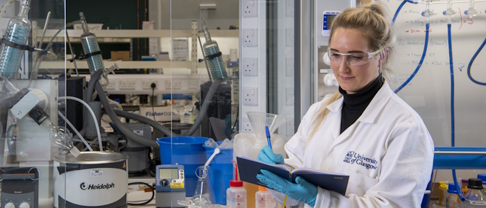 Student at work taking notes in a lab