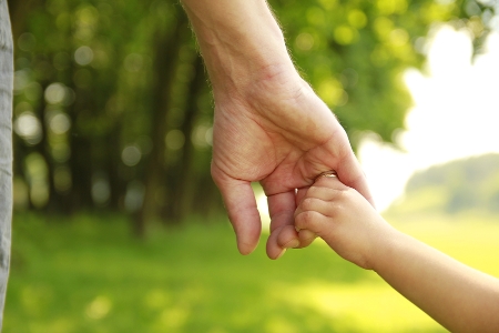 parent and young child hand-in-hand