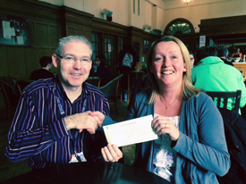 Derek 'DJ' Johnston presents a cheque for £2534 to Carolyn Thornton of Make-a-Wish