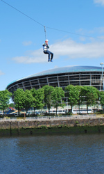 Image of a person on zip slide acorss the River Clyde
