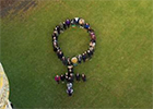 Arial Photo of  group of people in the shape of the pictogram for Venus which represents the female.