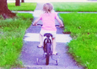 Image of child on bike with training wheels