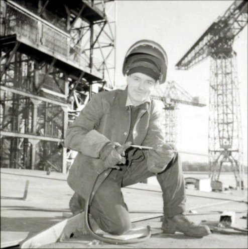 The welder smiles for the camera.