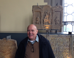 Donald McInnes standing in front of the Roman distance slab he discovered.