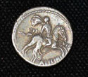 The back (reverse) of a Roman Republican silver coin with a galloping horseman (RRC 454/1; GLAHMS 22464)