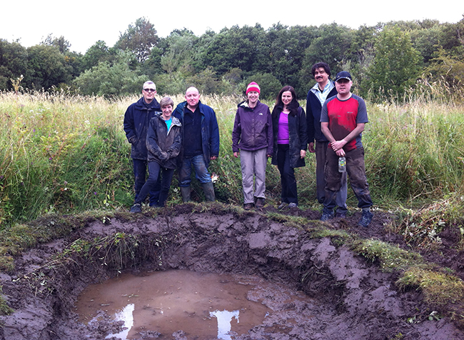 Volunteers digging pond