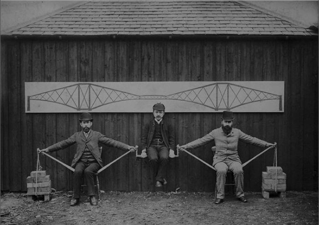 Watanabe (centre) demonstrating the cantilever bridge principle with Sir John Fowler and Sir Benjamin Baker