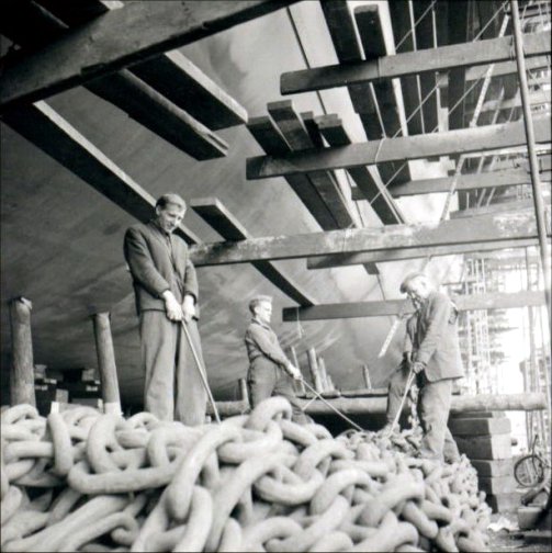 Workers checking the drag chains.