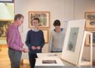 Hunterian curator Peter Black with colleagues looking at German Expressionist prints in the Hunterian Art Gallery.