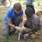 Sarah Cleaveland with Tanzanian boy and dog