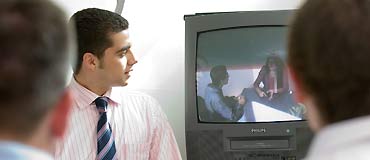 Picture of students observing patient and doctor interview technique via television