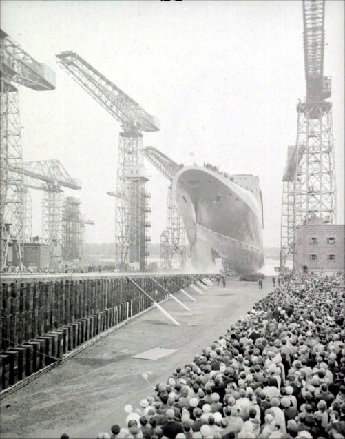 The QE2 slides down the slip way.