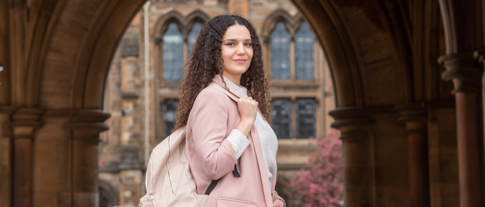 A female student chat outside the quadrangle