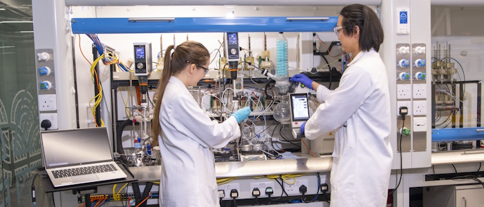 Two student technicians in a research lab