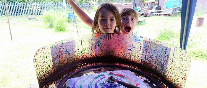 Two girls enjoying spin art at a gala day