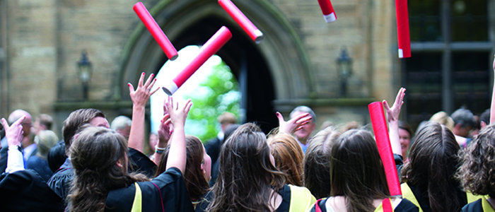 Graduates throwing scrolls in the air