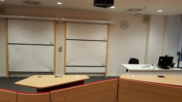 Raked collaborative lecture theatre with fixed seating, whiteboards, visualiser, and PC