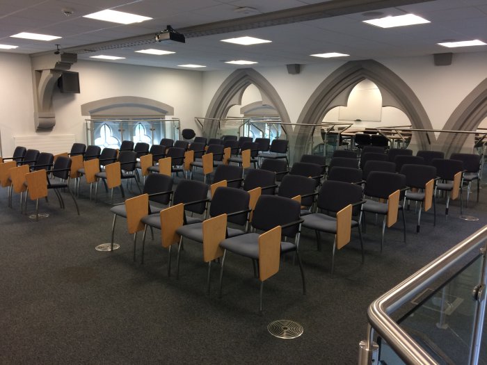 Flat floored teaching room with rows of tablet chairs