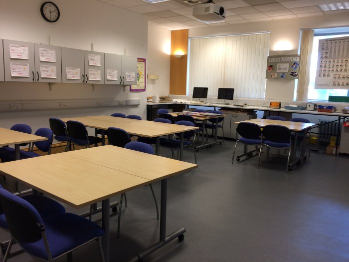 Flat floored teaching lab with groups of tables and chairs