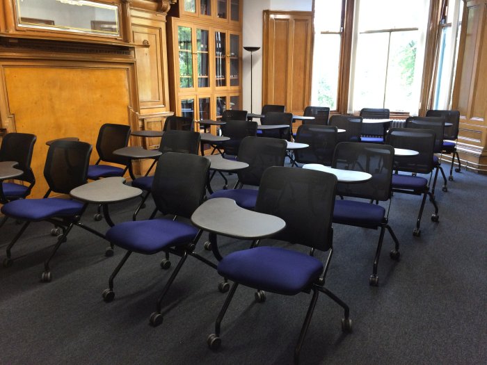 Flat floored teaching room with rows of tablet chairs