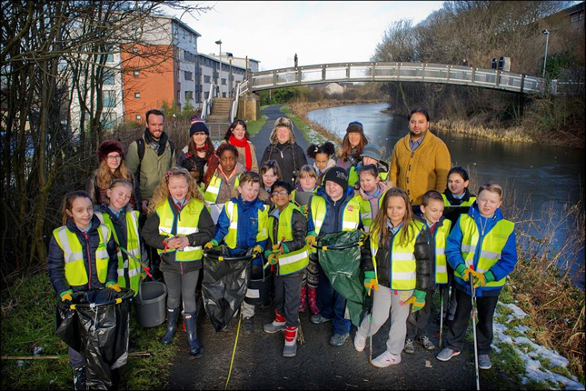 Image of children and community volunters taking part in Cleaner Canal Science