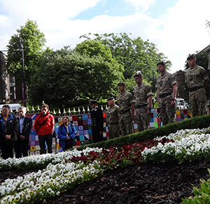 Image of a wooden cross being planted in the garden of remembrance