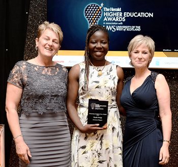 Claudia Wasige accepting her prize from Professor Jeanne Keay, Vice-Principal & Pro Vice-Chancellor (International) University of the West of Scotland (left), with host Sally Magnusson