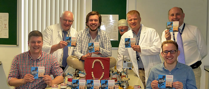 Members of Glasgow Dental Big Band and senior staff pose with CD