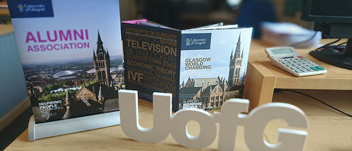 Alumni assocs banner, small UofG and booklet