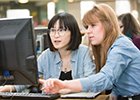 Two students working together at a computer
