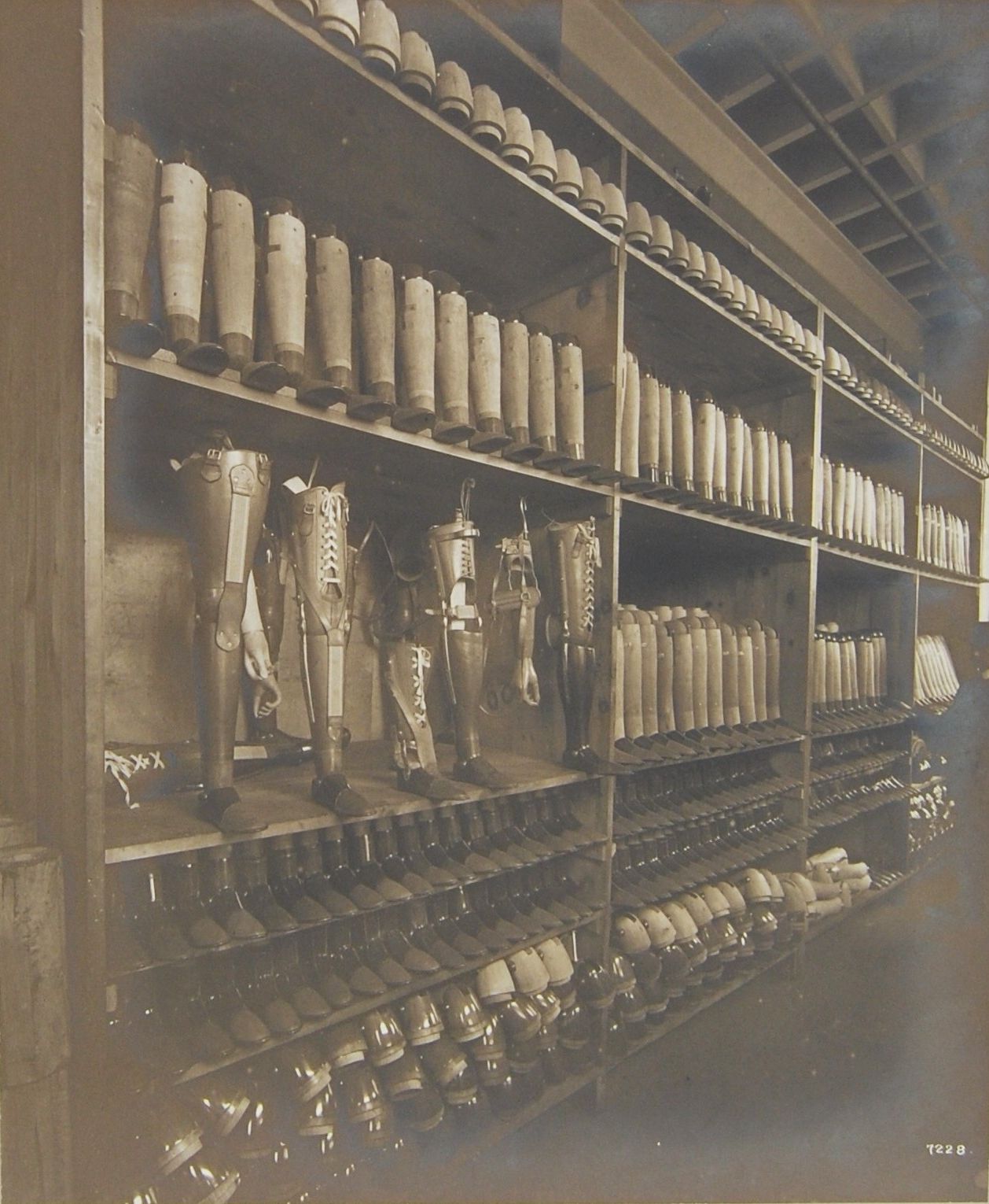 Photograph showing a corner of the limb store with parts of artificial limbs ready for assembly, take from ‘The Manufacture of Artificial Limbs for the Princess Louise Scottish Hospital for Limbless Sailors and Soldiers’,1917
