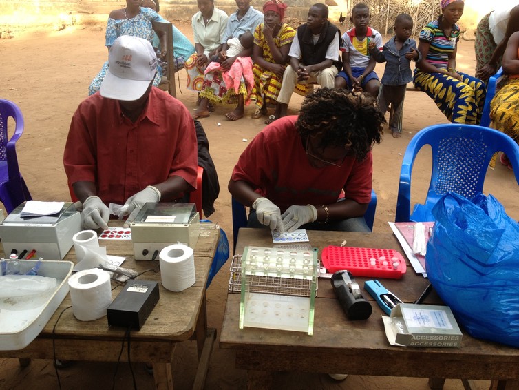 Field workers conduct blood tests for sleeping sickness in Guinea.