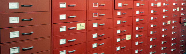 a long set of red filing drawers