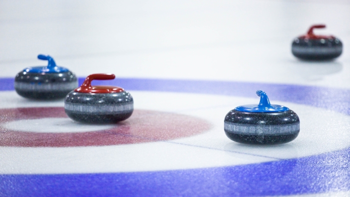 image of a curling rink and curling stones