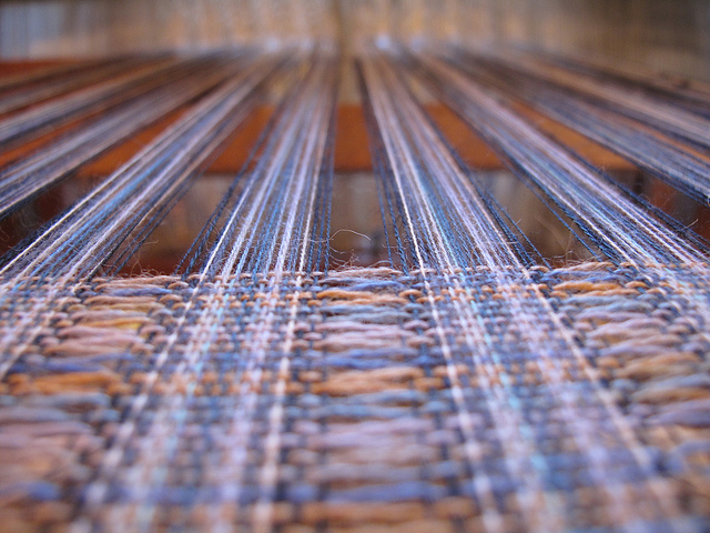 Close up of wool on a large weaving loom